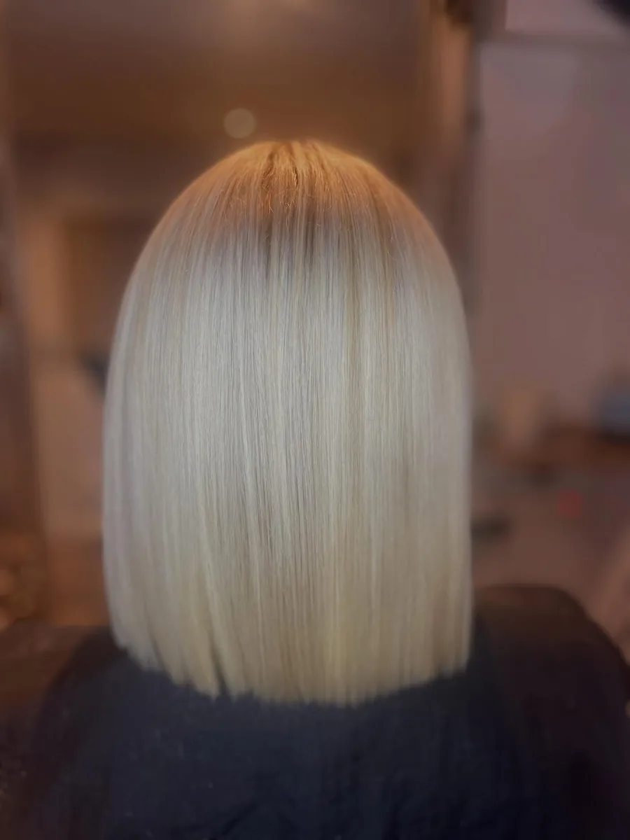 A platinum blonde bob from behind, blunt through the ends