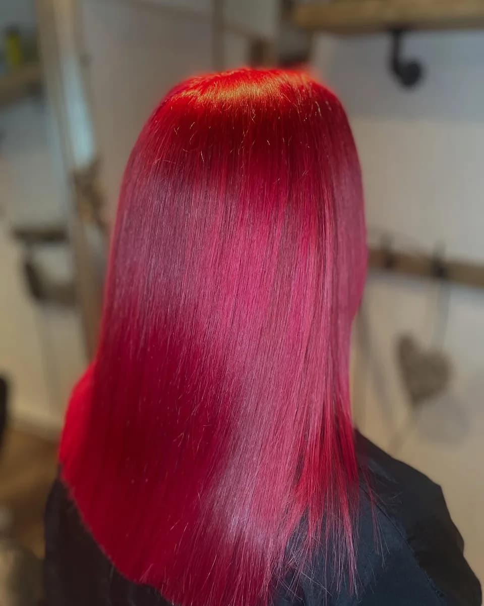 Vivid magenta pink on long hair, blow-dried poker straight